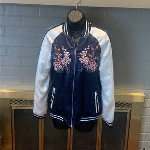 Navy bomber jacket with flower design.